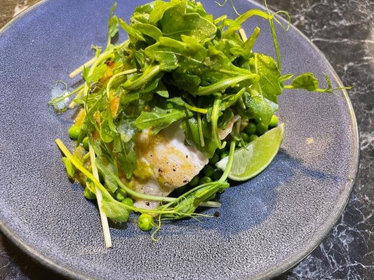 Barramundi with Garlic Parmesan Smashed Potatoes, Butter Peas, Demeter, and a Rocket Garnish